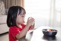 Asian Chinese little girl having breakfast with milk Royalty Free Stock Photo