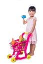 Asian Chinese little girl holding credit card with shopping trolley full of vegetables Royalty Free Stock Photo