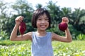 Asian Chinese Little Girl holding purple potato in organic farm Royalty Free Stock Photo