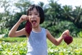 Asian Chinese Little Girl holding purple potato in organic farm Royalty Free Stock Photo