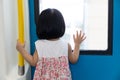 Asian Chinese little girl inside train looking beside the window Royalty Free Stock Photo