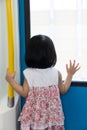 Asian Chinese little girl inside train looking beside the window Royalty Free Stock Photo