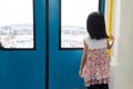 Asian Chinese little girl inside train looking beside the window Royalty Free Stock Photo