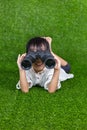 Asian Chinese little girl looking through binoculars Royalty Free Stock Photo