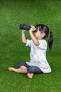 Asian Chinese little girl looking through binoculars Royalty Free Stock Photo