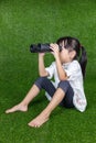 Asian Chinese little girl looking through binoculars Royalty Free Stock Photo