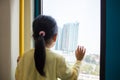 Asian Chinese little girl looking far way beside the window Royalty Free Stock Photo