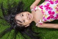 Asian Chinese little girl lying on the grass Royalty Free Stock Photo