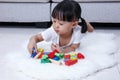 Asian Chinese little girl playing blocks on the floor Royalty Free Stock Photo