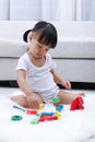 Asian Chinese little girl playing blocks on the floor Royalty Free Stock Photo