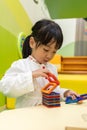 Asian Chinese little girl playing colorful magnet plastic blocks Royalty Free Stock Photo