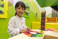 Asian Chinese little girl playing colorful magnet plastic blocks Royalty Free Stock Photo