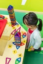 Asian Chinese little girl playing colorful magnet plastic blocks Royalty Free Stock Photo