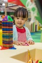 Asian Chinese little girl playing colorful magnet plastic blocks Royalty Free Stock Photo