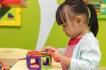 Asian Chinese little girl playing colorful magnet plastic blocks Royalty Free Stock Photo