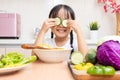 Asian Chinese little girl playing with cucumber Royalty Free Stock Photo