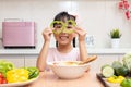 Asian Chinese little girl playing with green pepper Royalty Free Stock Photo
