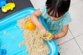 Asian Chinese little girl playing kinetic sand at home Royalty Free Stock Photo