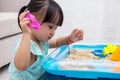 Asian Chinese little girl playing kinetic sand at home Royalty Free Stock Photo