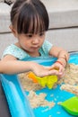 Asian Chinese little girl playing kinetic sand at home Royalty Free Stock Photo