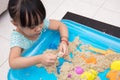 Asian Chinese little girl playing kinetic sand at home Royalty Free Stock Photo