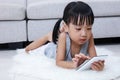 Asian Chinese little girl playing phone on the floor Royalty Free Stock Photo