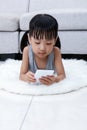 Asian Chinese little girl playing phone on the floor Royalty Free Stock Photo