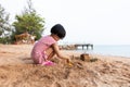 Asian Chinese little girl playing sand at beach Royalty Free Stock Photo