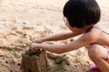 Asian Chinese little girl playing sand at beach Royalty Free Stock Photo