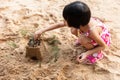 Asian Chinese little girl playing sand at beach Royalty Free Stock Photo