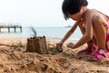 Asian Chinese little girl playing sand at beach Royalty Free Stock Photo