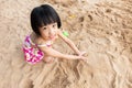 Asian Chinese little girl playing sand at beach Royalty Free Stock Photo