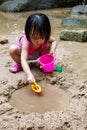 Asian Chinese little girl playing sand at creek Royalty Free Stock Photo