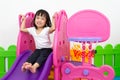 Asian Chinese little girl playing on the slide Royalty Free Stock Photo