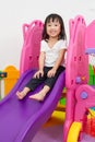 Asian Chinese little girl playing on the slide Royalty Free Stock Photo