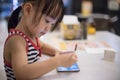 Asian Chinese little girl playing smartphone Royalty Free Stock Photo