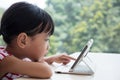 Asian Chinese little girl playing tablet computer