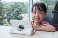 Asian Chinese little girl playing tablet computer Royalty Free Stock Photo