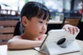 Asian Chinese little girl playing tablet computer Royalty Free Stock Photo