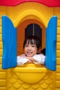 Asian Chinese little girl playing in toy house Royalty Free Stock Photo