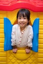 Asian Chinese little girl playing in toy house Royalty Free Stock Photo