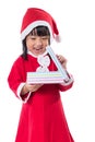 Asian Chinese little girl in santa costume holding gift box Royalty Free Stock Photo