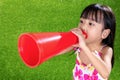 Asian Chinese little girl shouting through megaphone Royalty Free Stock Photo