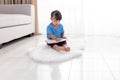 Asian Chinese little girl sitting on the floor drawing