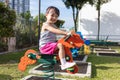 Asian Chinese little girl sitting on seesaw