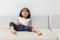 Asian Chinese little girl sitting on the sofa crying Royalty Free Stock Photo