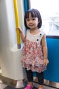 Asian Chinese little girl standing inside a MRT transit Royalty Free Stock Photo