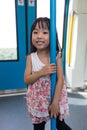 Asian Chinese little girl standing inside a MRT transit Royalty Free Stock Photo