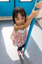 Asian Chinese little girl standing inside a MRT transit Royalty Free Stock Photo