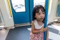 Asian Chinese little girl standing inside a MRT transit Royalty Free Stock Photo